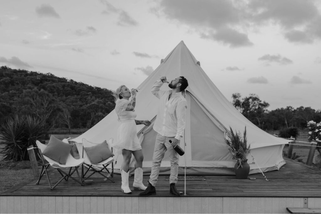 Couple sharing a joyful moment outside their luxury bell tent