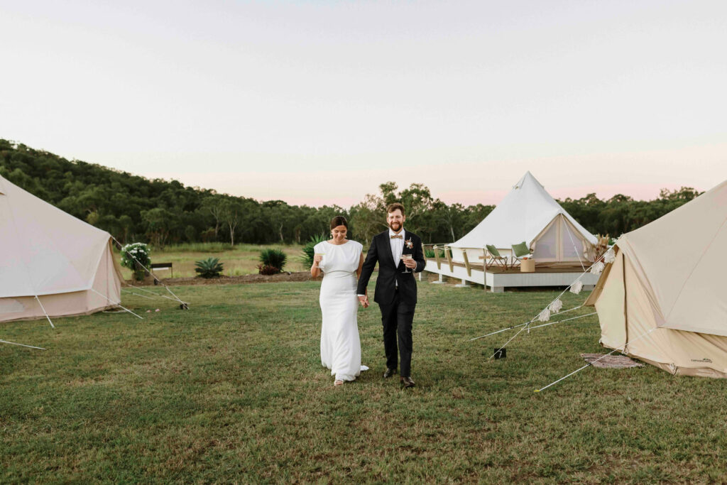 Couple walking through The Salty Lime Co glamping camp