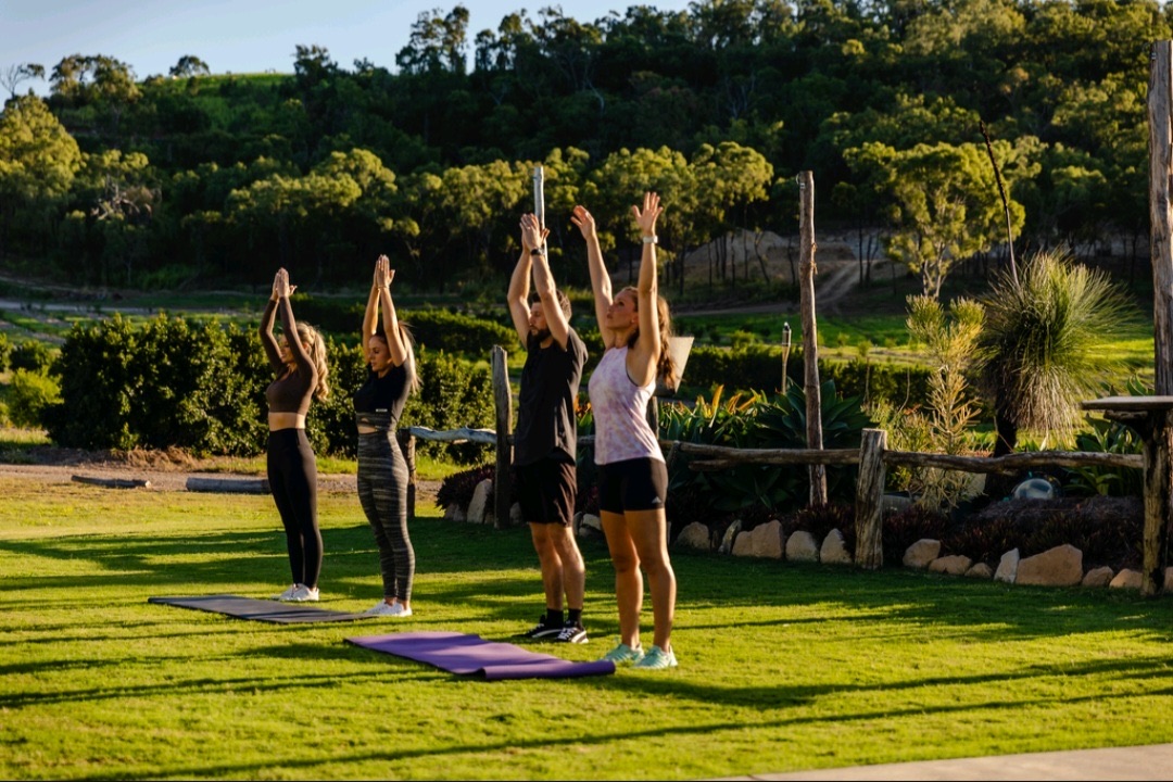 Outdoor yoga session on the landscaped lawn at The Salty Lime Co