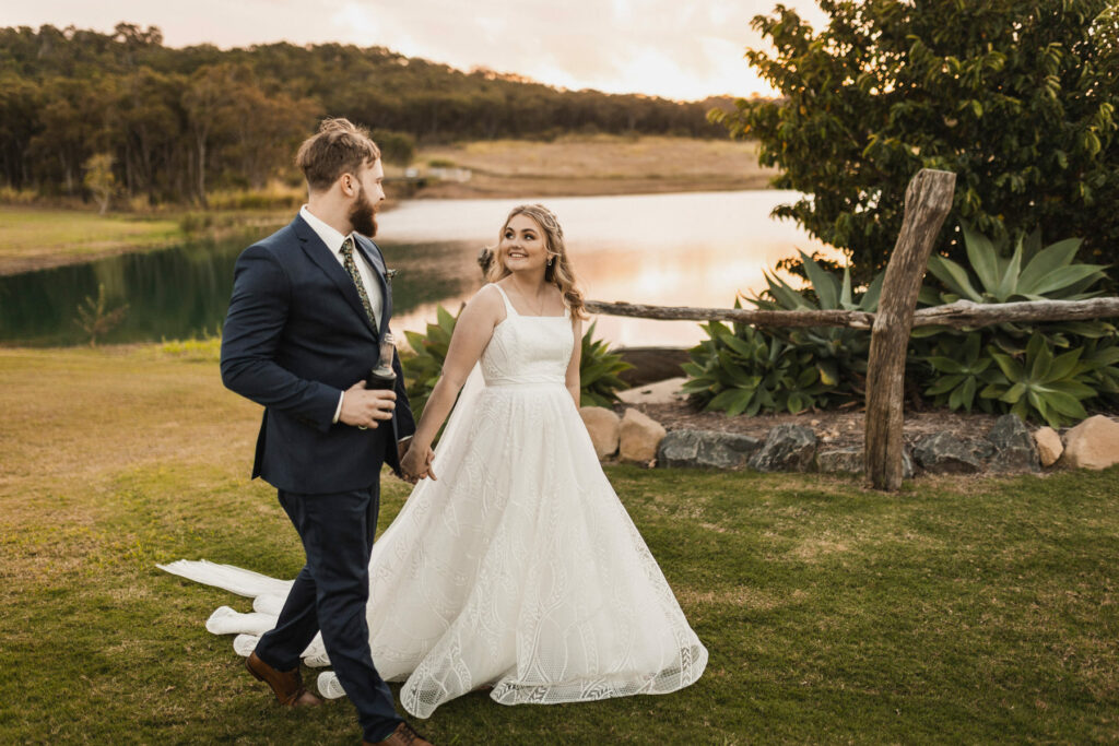 Newlyweds beside the lake at The Salty Lime Co wedding venue