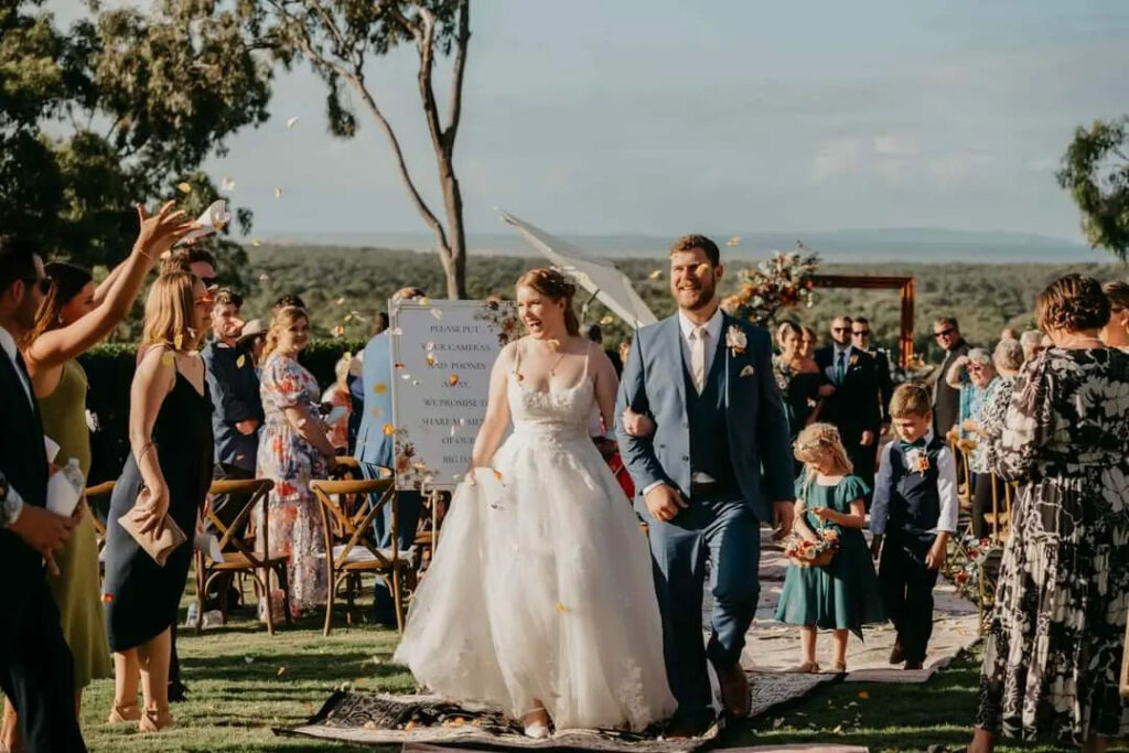 Newlyweds celebrating with guests after their outdoor ceremony