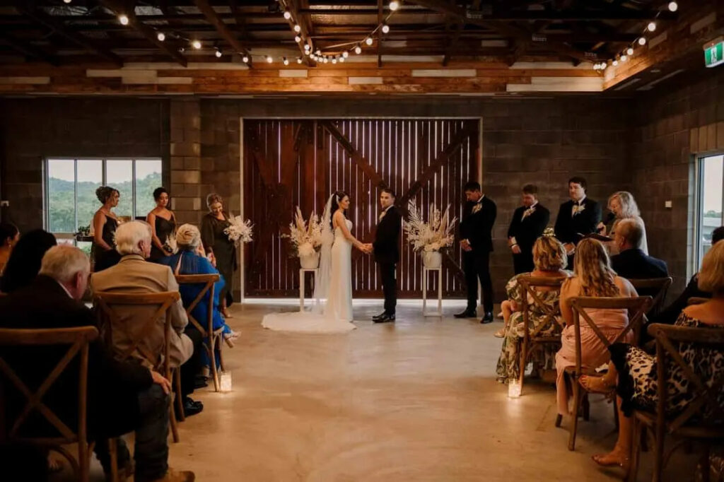 Indoor wedding ceremony in the rustic reception venue