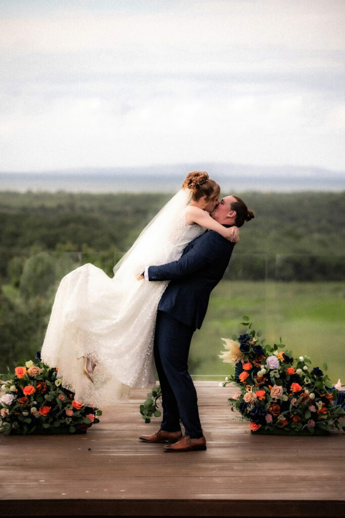 Joyful wedding couple portrait overlooking the countryside