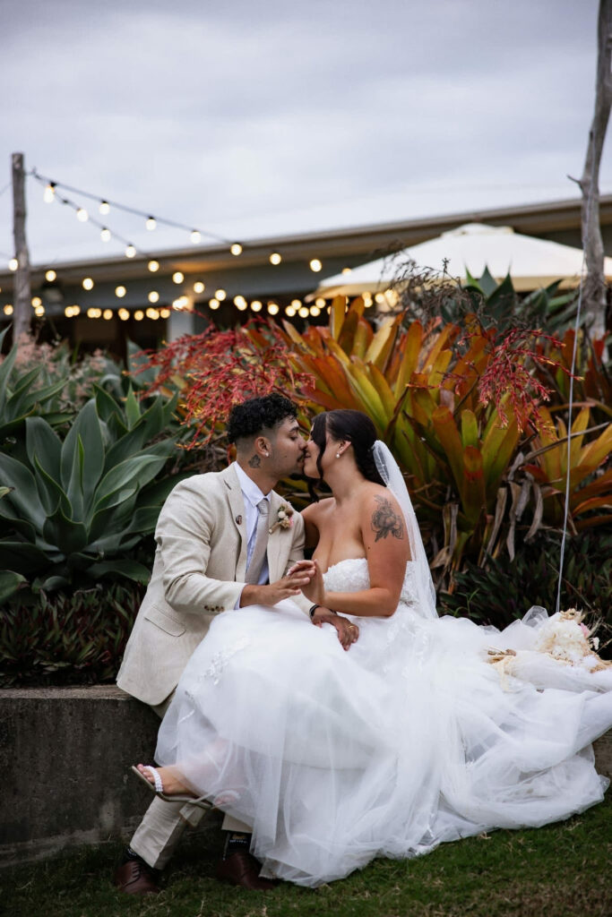 Newlyweds relaxing together in the tropical gardens