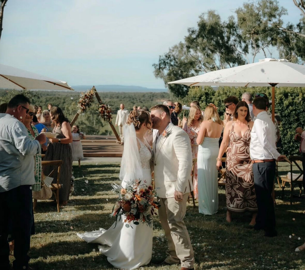 Wedding guests celebrating an outdoor ceremony