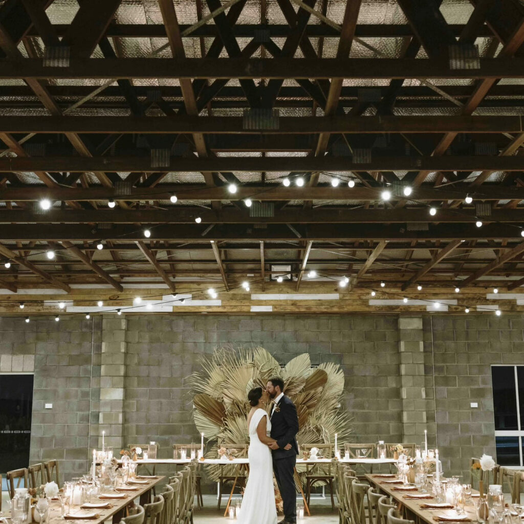 Rustic wedding reception tables inside the venue
