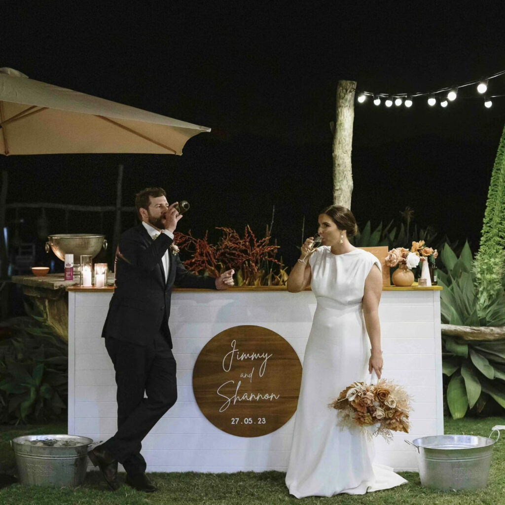 Newlyweds at a personalised wedding bar