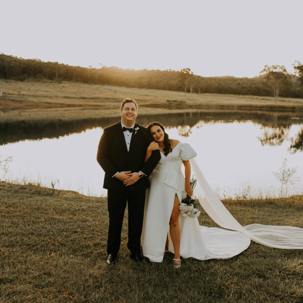 Wedding couple portrait beside the lake at sunset
