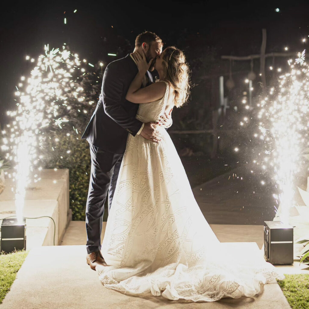 Newlyweds framed by sparklers at their evening reception