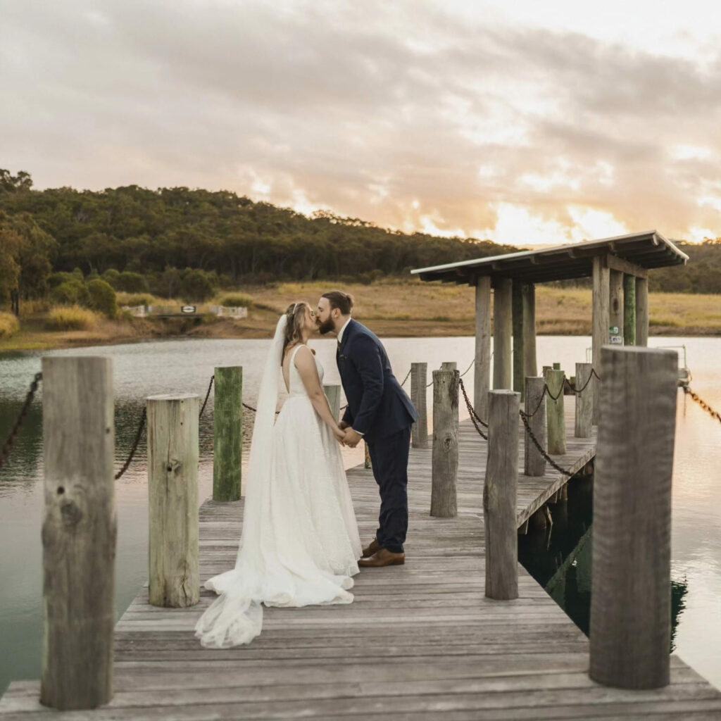 Wedding couple on the jetty overlooking the lake