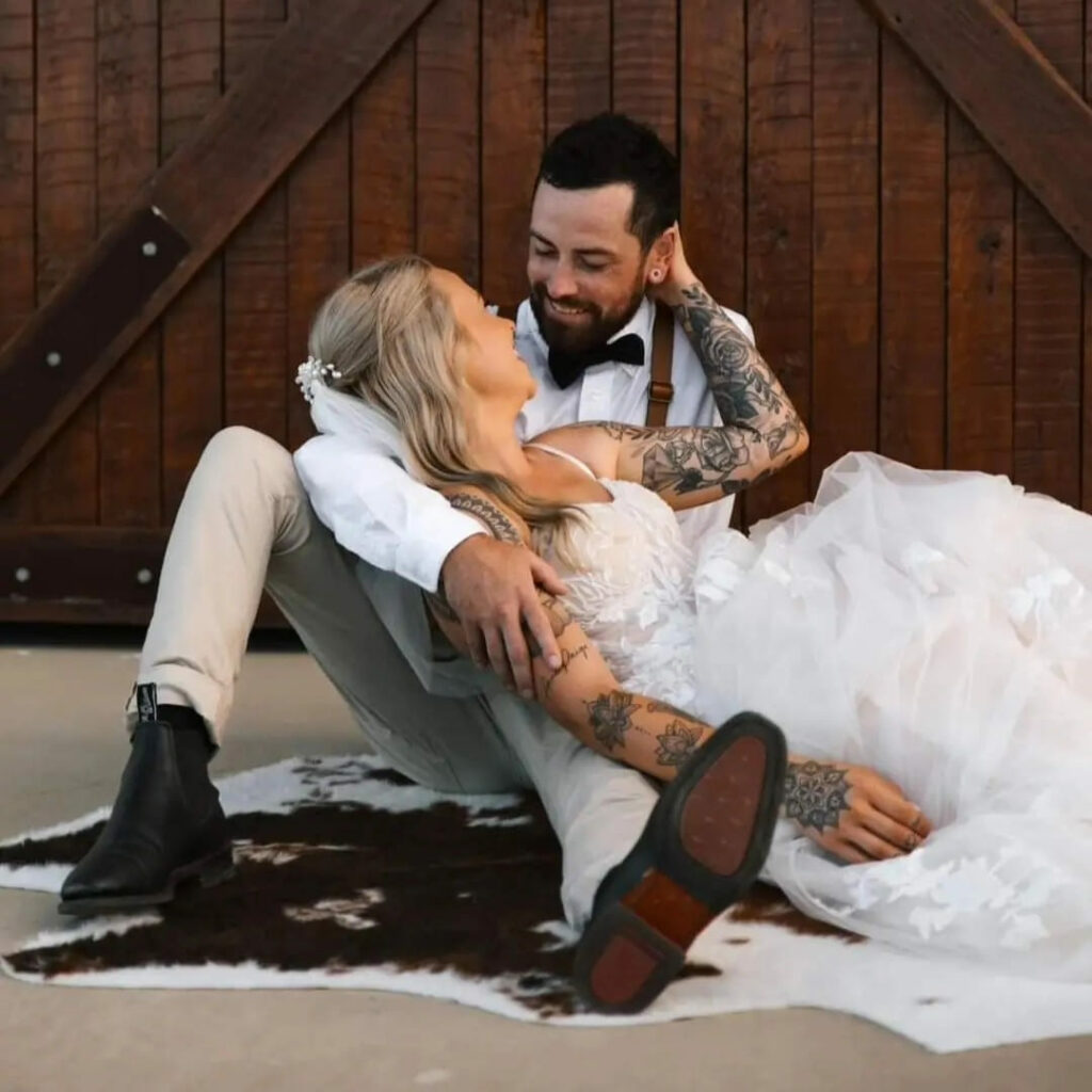 Newlyweds relaxing together outside the rustic venue