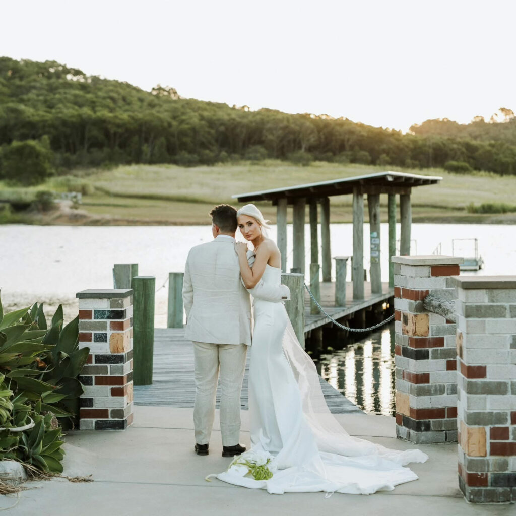 Wedding couple beside the lake and jetty