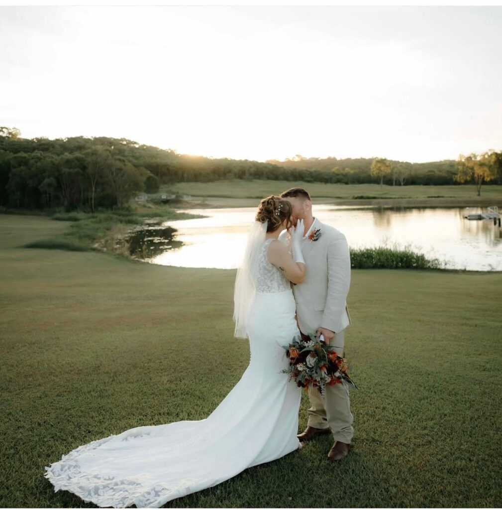 Bride in the golden light beside the lake