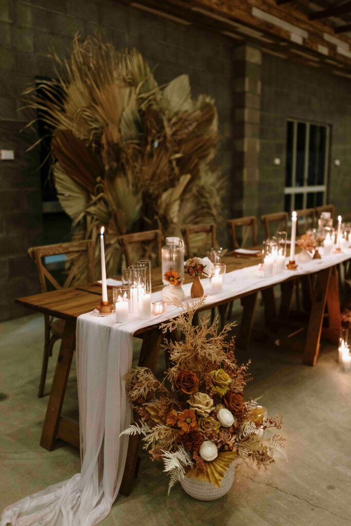 Bridal table with candles and warm rustic styling