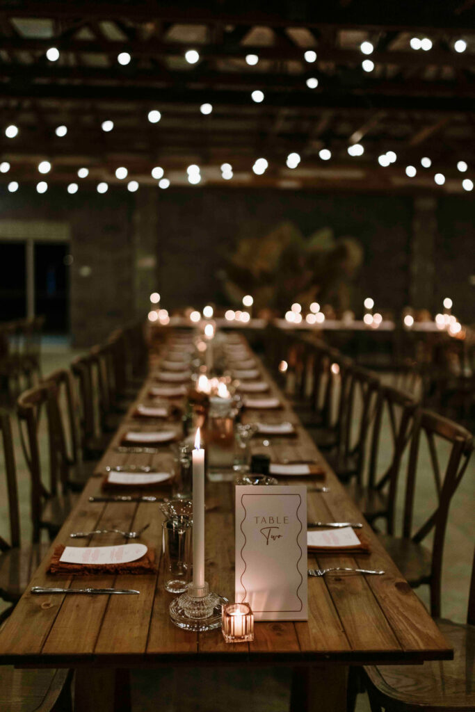 Candlelit wedding reception table at The Salty Lime Co